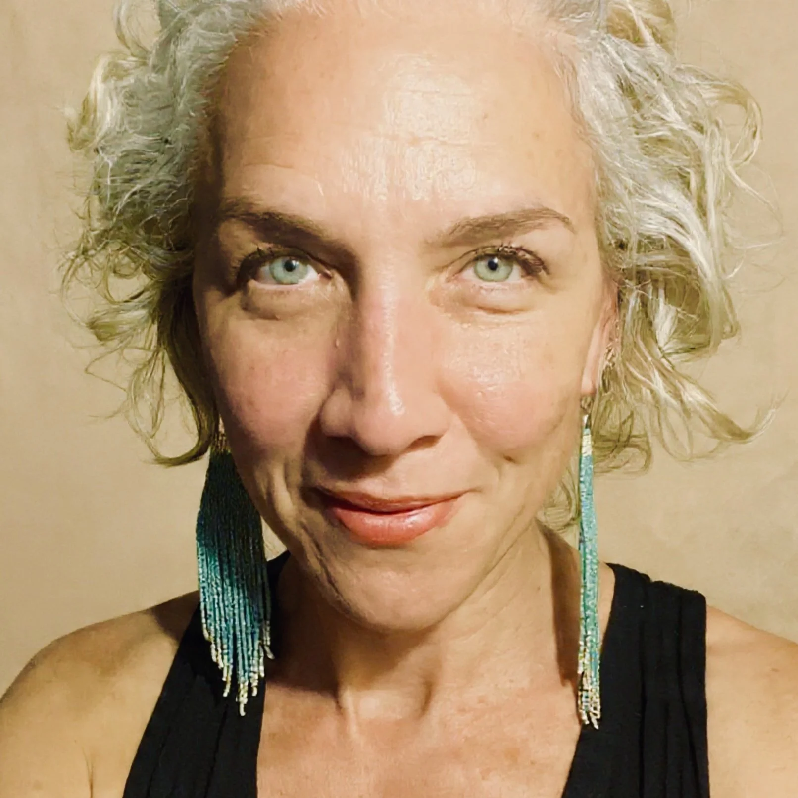 rodasi campbell yoga meditation teacher smiling with beige background