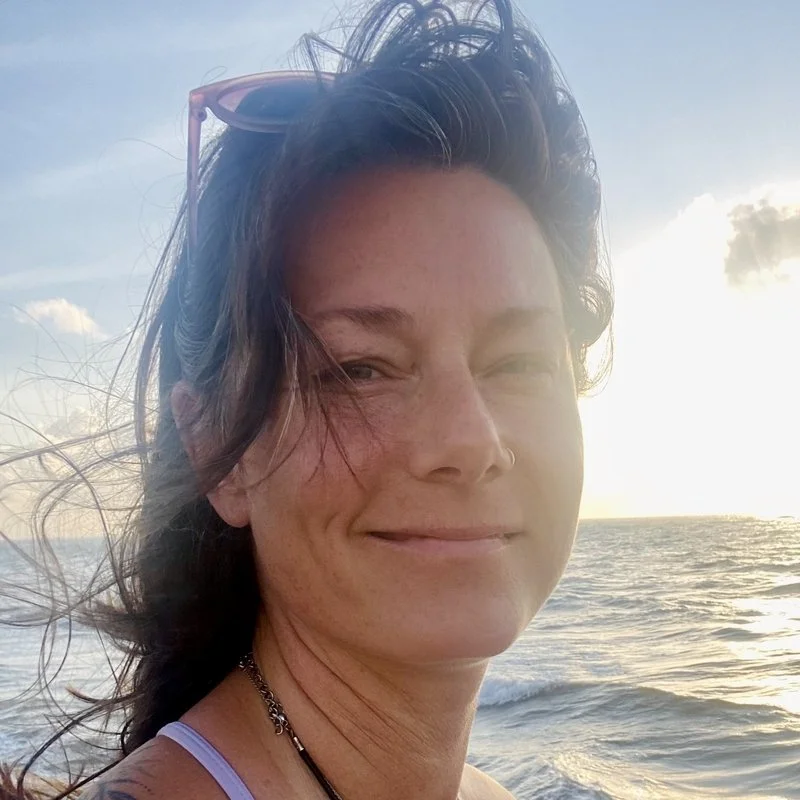 sarah louisignau smiling with water behind