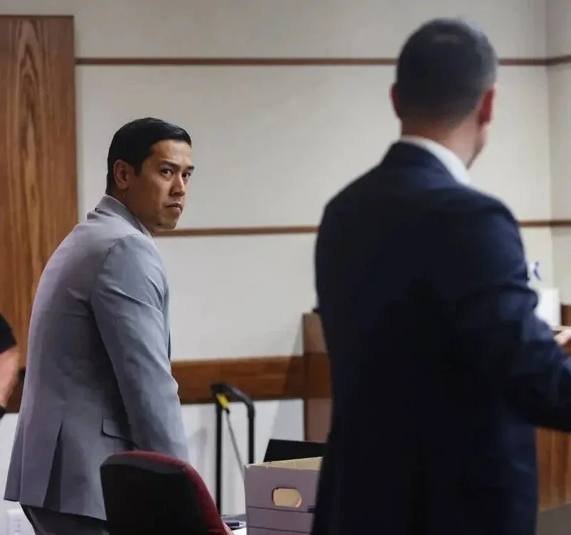 elect judicial candidate 8th judicial district court department 28 alex quagge, in a gray suit looks over his shoulder in a court room or formal setting, during bail argument on a DUI death case.