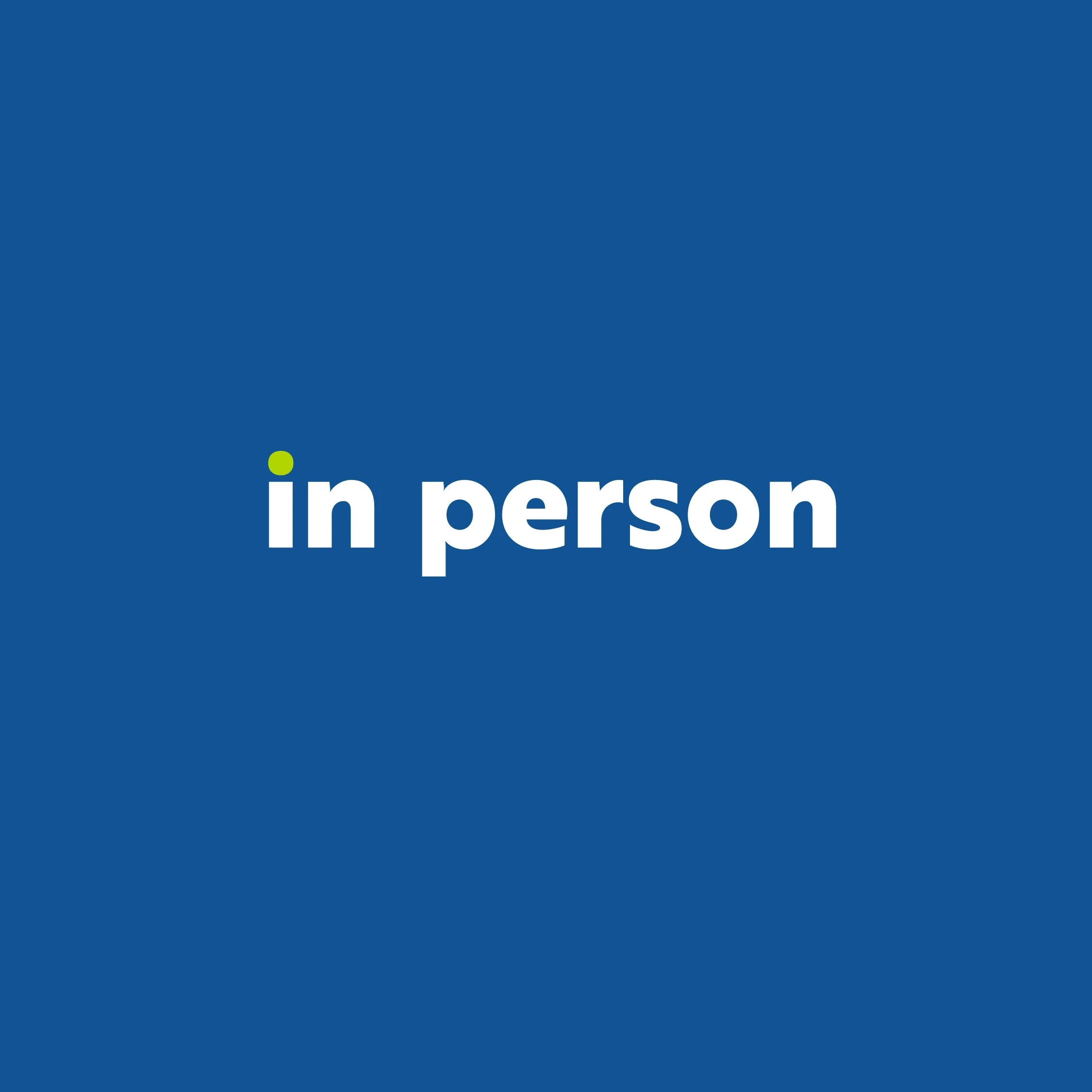 Blue background with white text that says 'in person' and a small green circle dotting the 'i'.