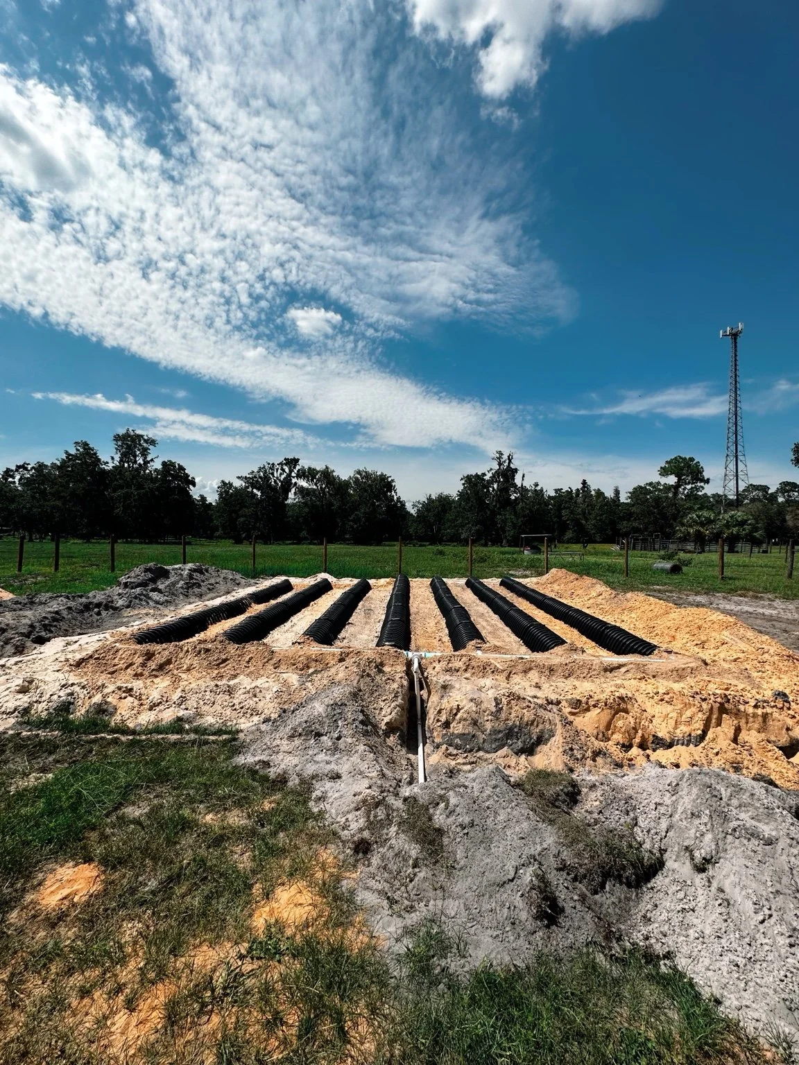 Newly constructed septic mound with visible chambers before final cover in a residential installation