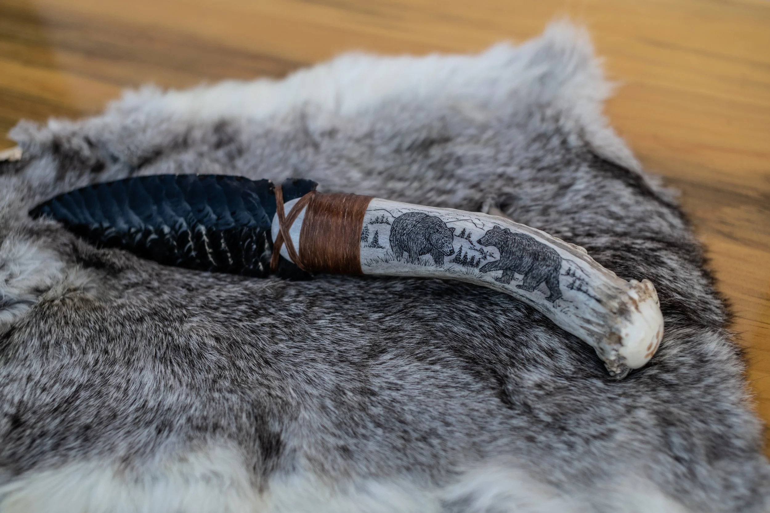 Museum-quality scrimshaw by our master in-house artist transforms elk jaws, deer jaws, wolf jaws, antler, buffalo bone, and ulu handles into living canvases. Detailed scenes of elk, deer, wolf, buffalo, bear, and eagle amid their native landscapes ar
