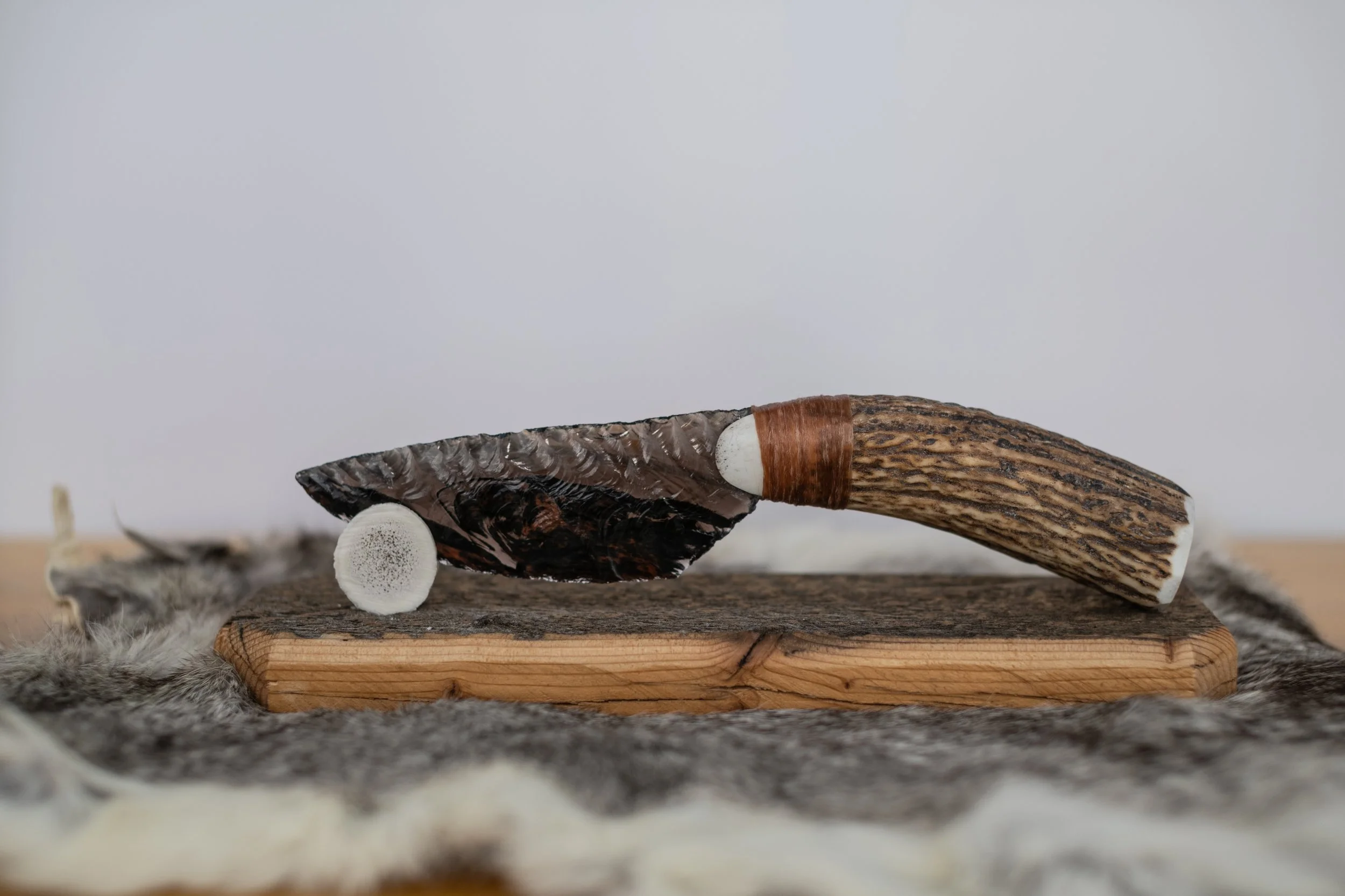 Hand-crafted from authentic reclaimed barn wood and crowned with a naturally shed antler tine, this elegant stand gently cradles and proudly displays your obsidian knife. Timeless rustic character meets perfect function—an essential, heirloom-quality