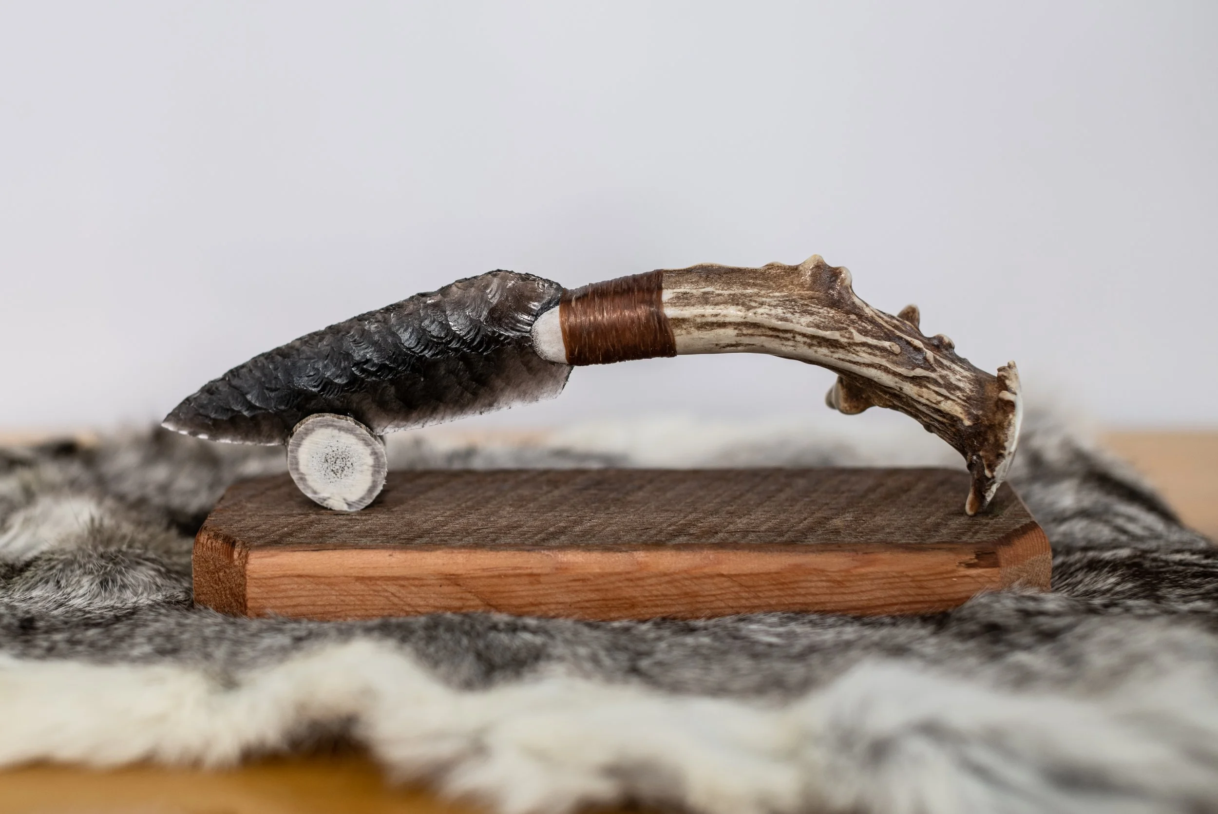 Hand-crafted from authentic reclaimed barn wood and crowned with a naturally shed antler tine, this elegant stand gently cradles and proudly displays your obsidian knife. Timeless rustic character meets perfect function—an essential, heirloom-quality