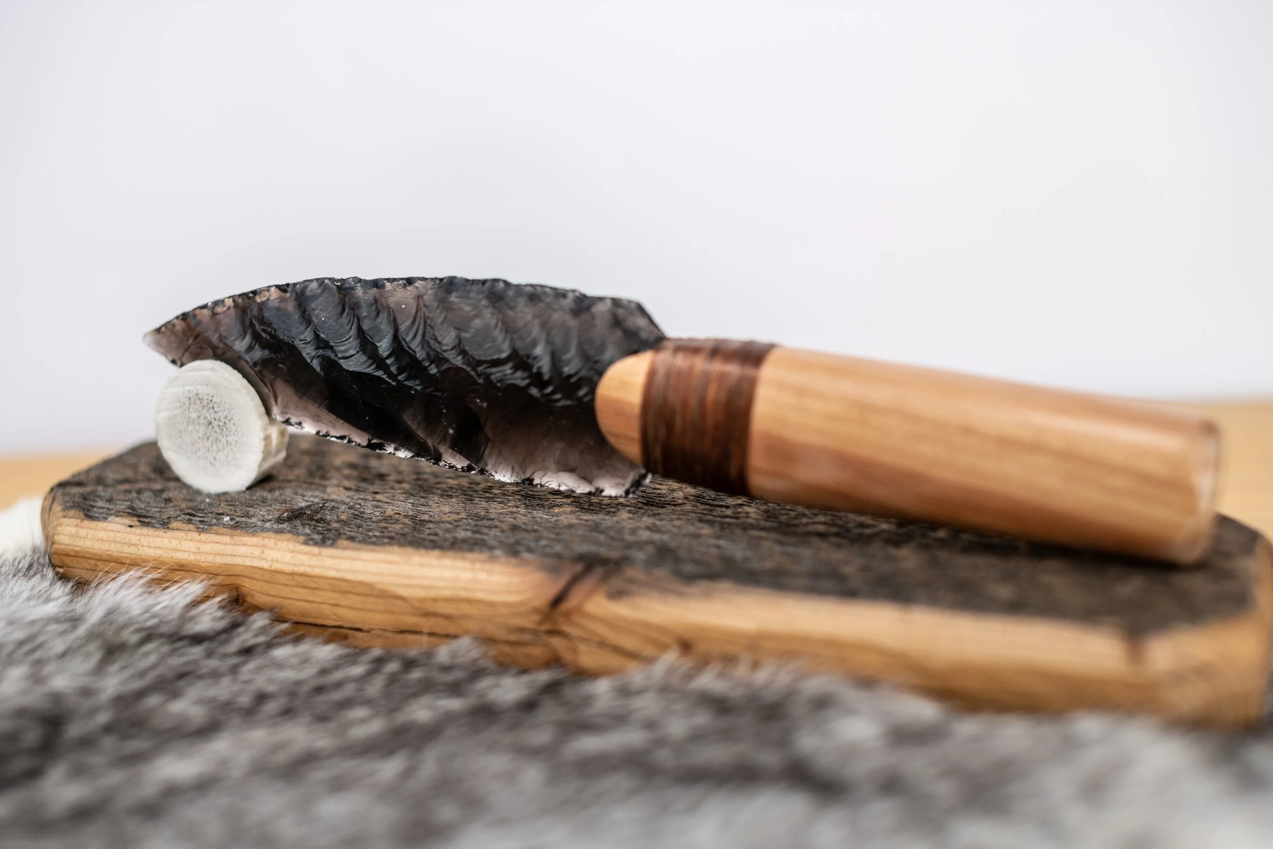 Elegantly simple obsidian blade knives with smooth, hand-shaped handles of locally sourced hardwood. Bound with sinew and crafted for perfect balance and feel, these timeless pieces blend natural warmth with ancient sharpness—a quiet celebration of w