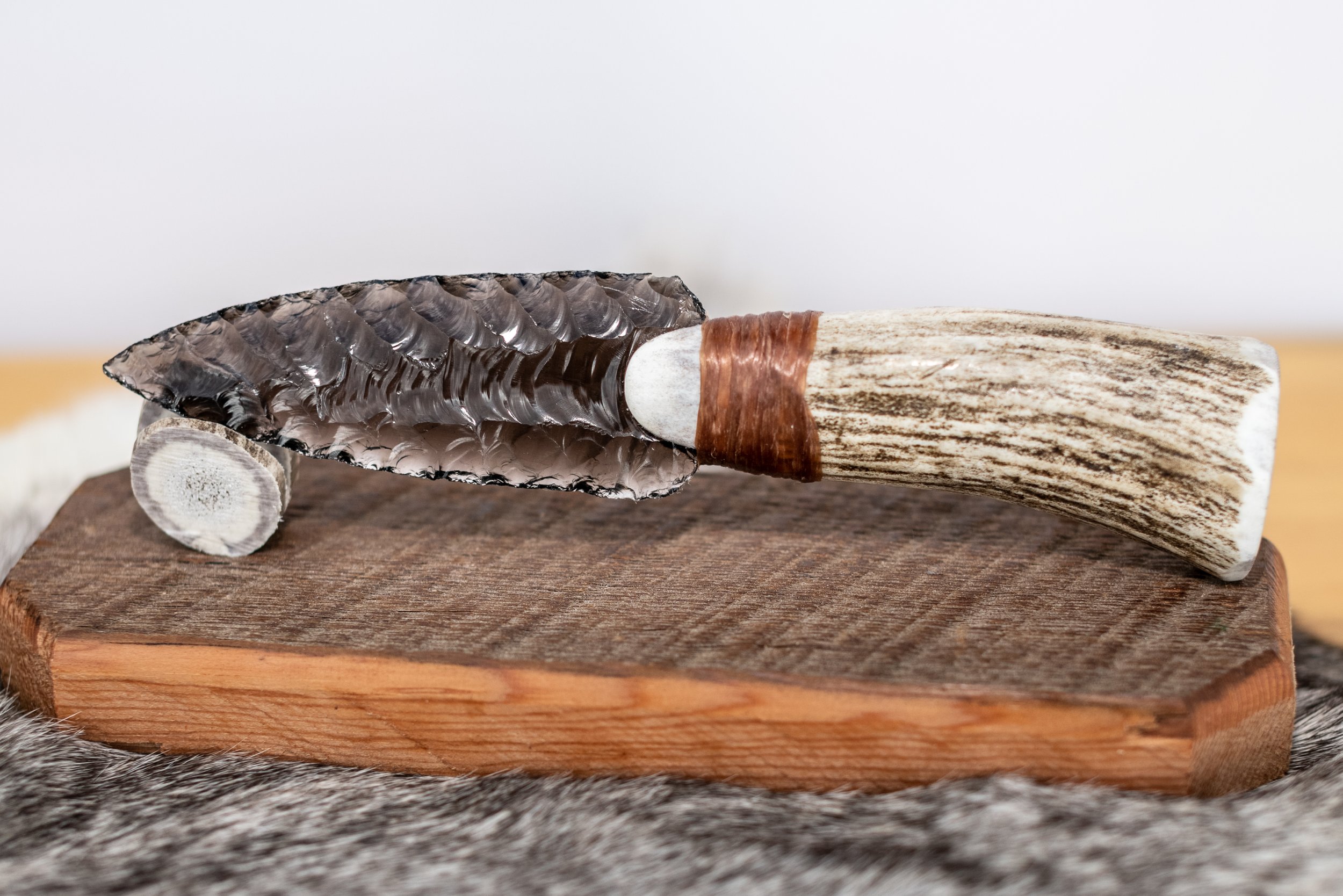 Hand-crafted from authentic reclaimed barn wood and crowned with a naturally shed antler tine, this elegant stand gently cradles and proudly displays your obsidian knife. Timeless rustic character meets perfect function—an essential, heirloom-quality
