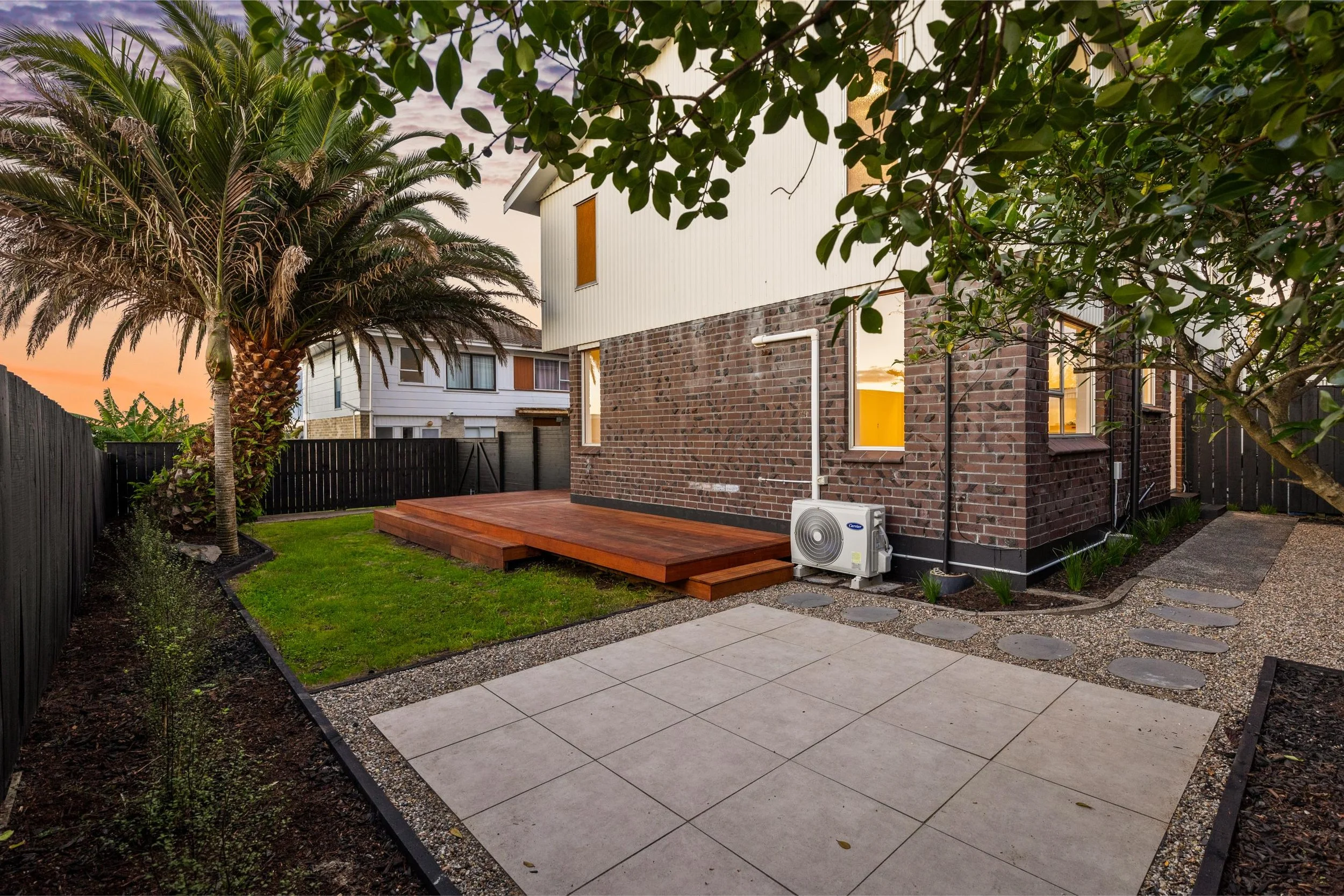 Town house outdoor living renovation including decking and paved area