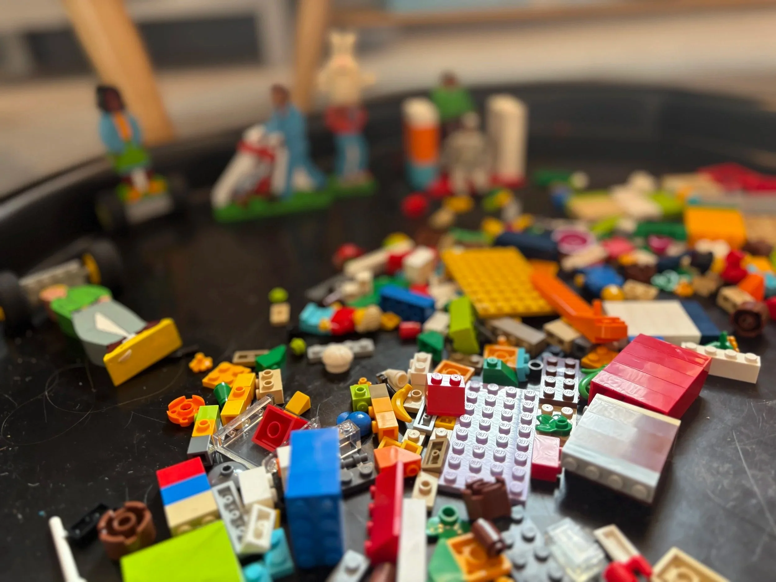 Colourful building bricks and figures ready for play in the therapy room