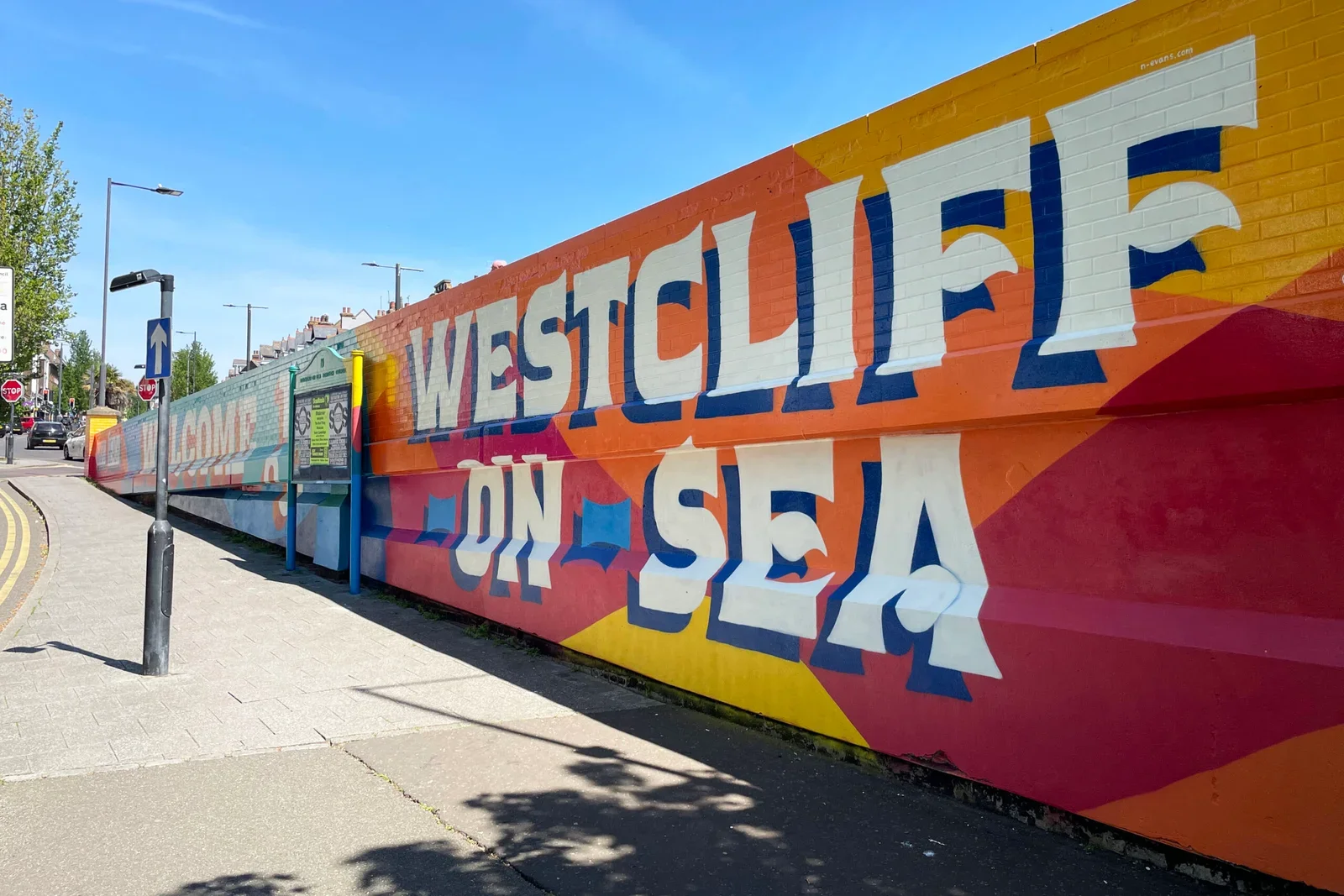 The Westcliff Welcome mural greets people arriving at Westcliff station. Its colours and lettering draw on the local area, the sea and the movement of people through it.