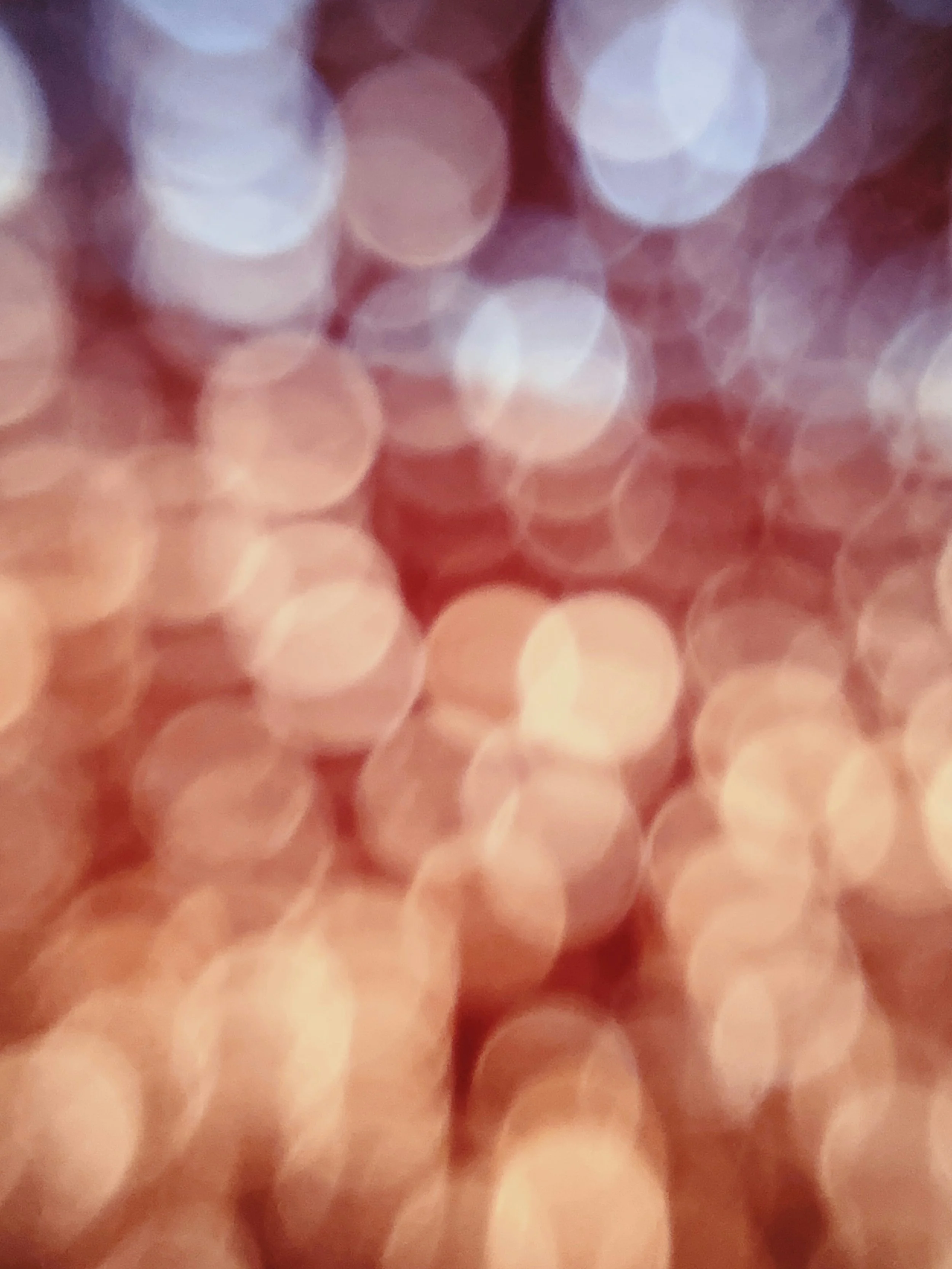 Close-up of bokeh lights in shades of pink, peach, and purple