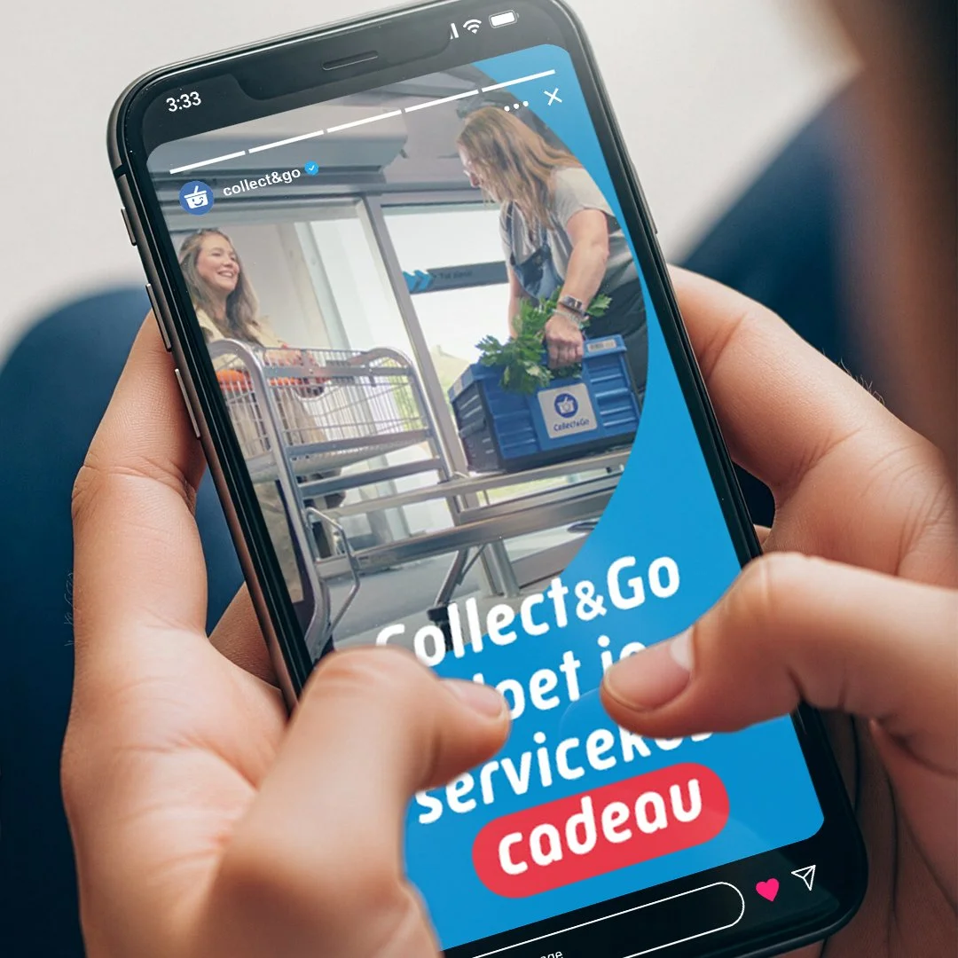Hands holding a smartphone showing a Collect&Go message about customers picking up groceries in the store.