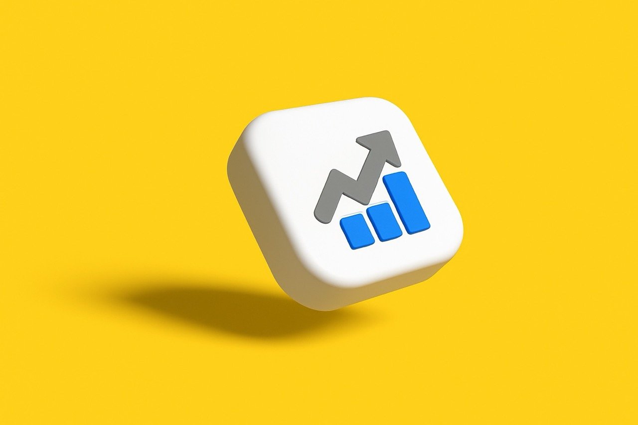 The image is a 3D graphic depicting a white square with rounded corners floating against a plain yellow background. The white square has a chart icon on its front face. The icon consists of a grey line graph with an arrow pointing up and to the right