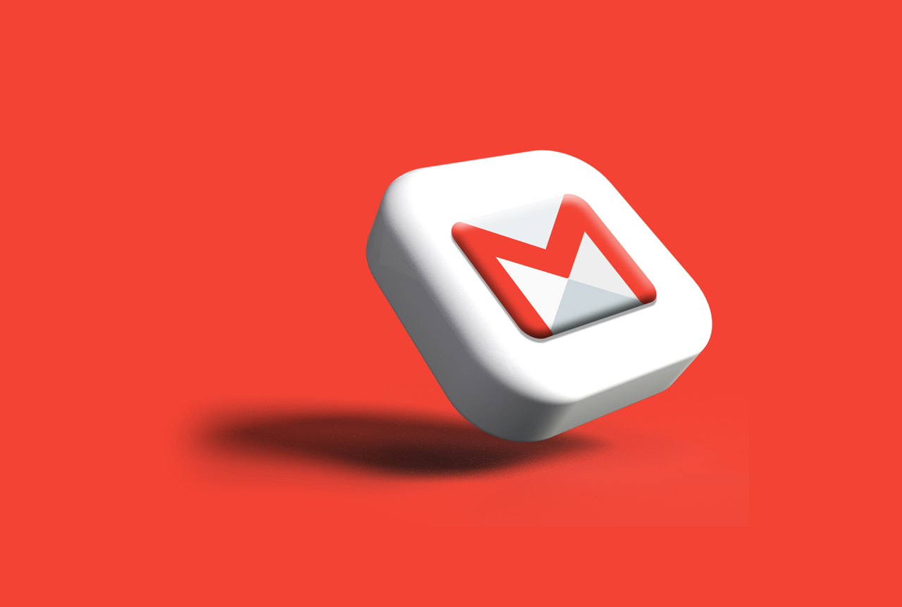 The image depicts a 3D rendition of the Gmail logo. The logo is a white, rounded square with the characteristic red and white "M" envelope symbol. The object appears to be slightly suspended above a solid, reddish-orange background.