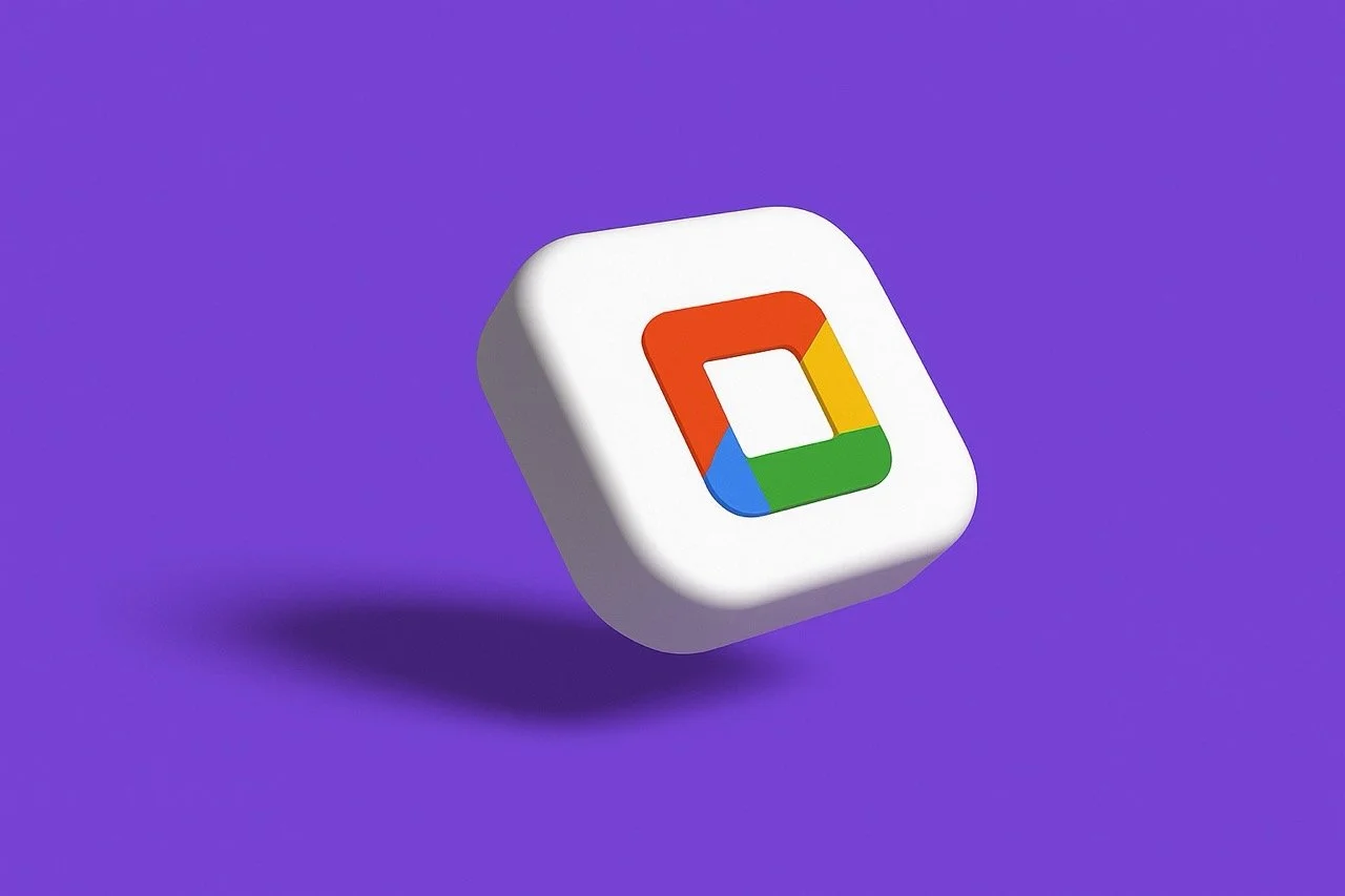 The image shows a 3D, white, softly-rounded square icon floating on a solid purple background. The center of the white square has a smaller, rounded square inset with the characteristic four colors of Google Drive: red, yellow, green, and blue. The i