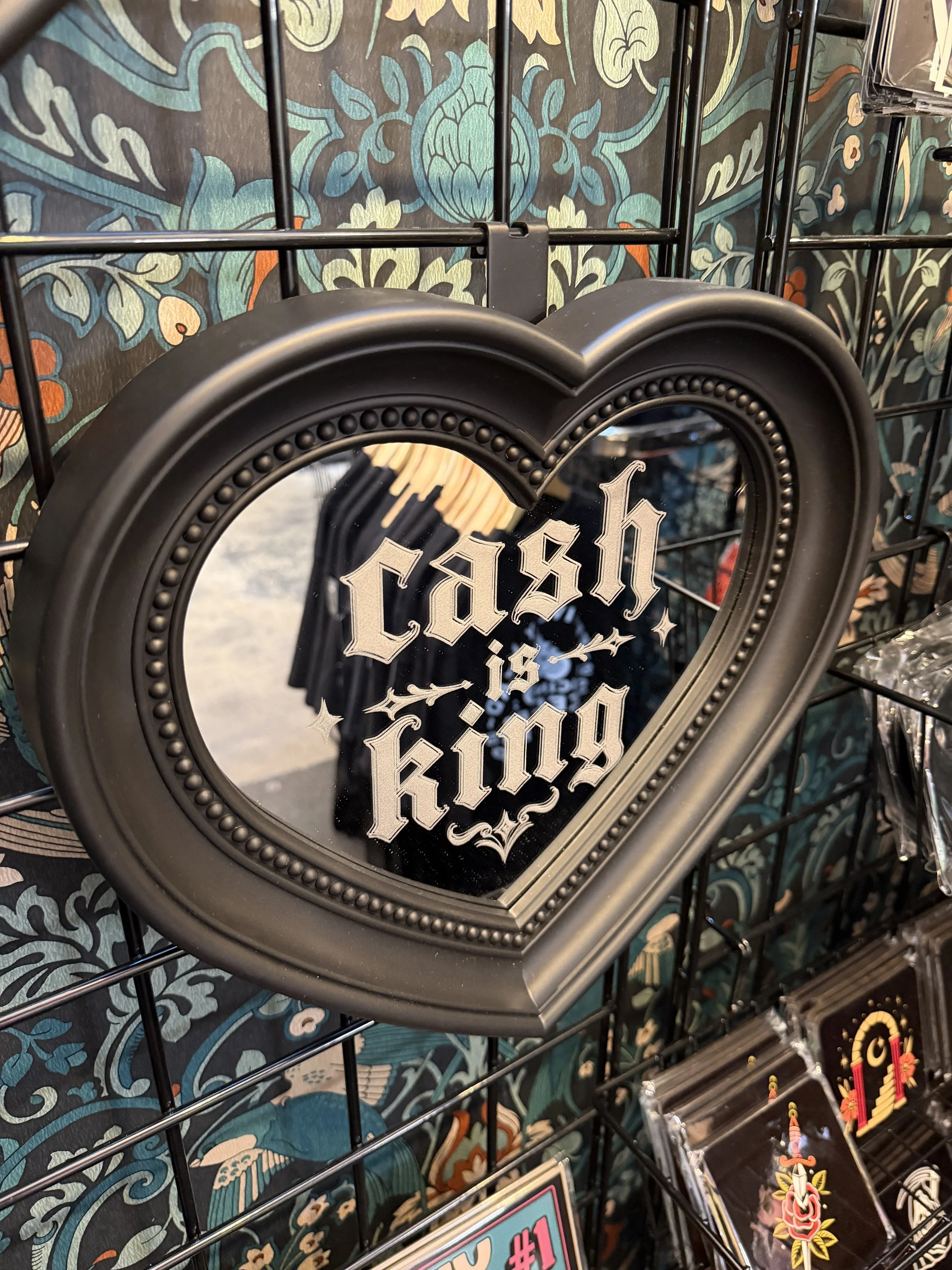 Cash is King heart mirror hanging on a shop wall display