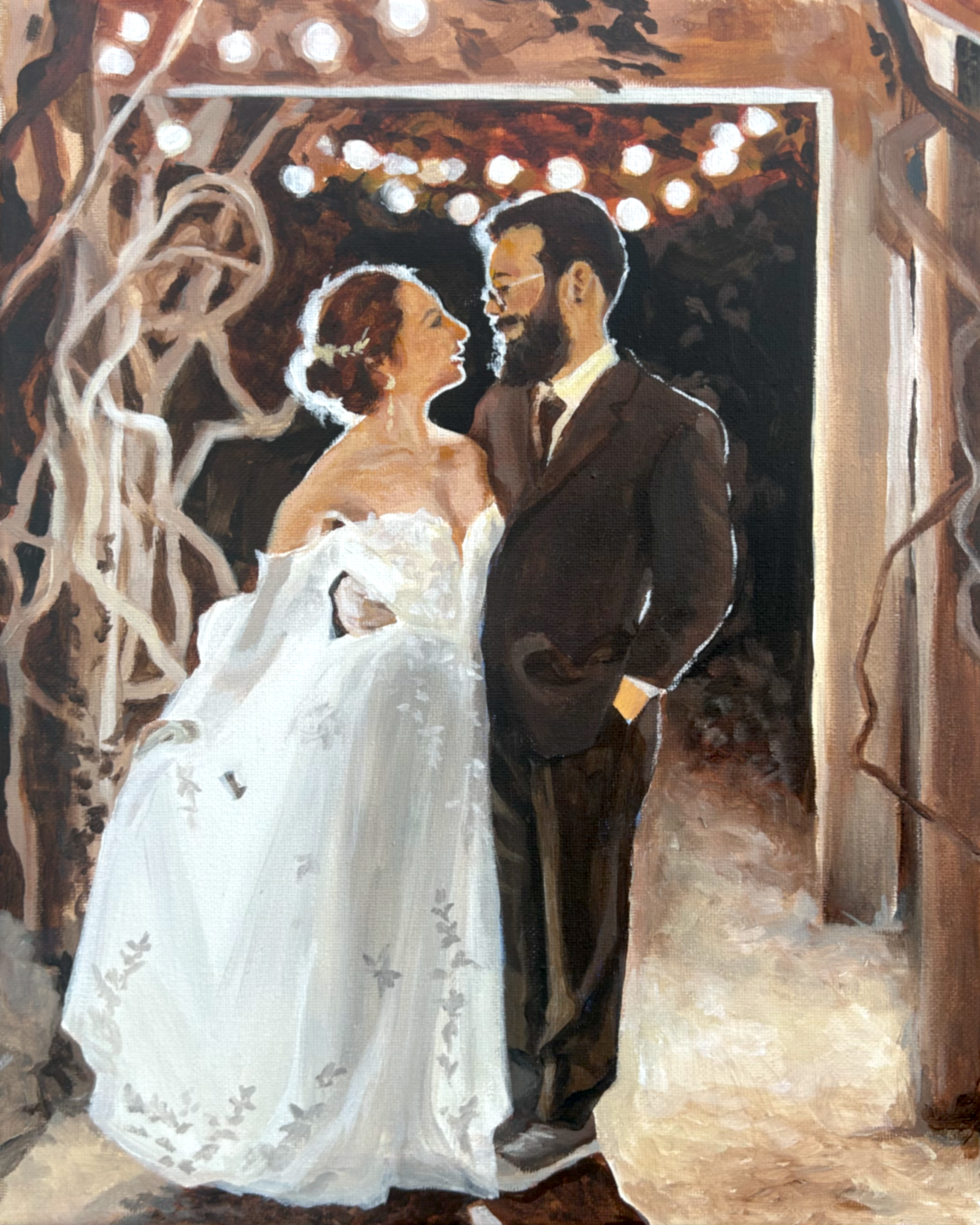a couple standing in front of a vine trellis with cafe lighting