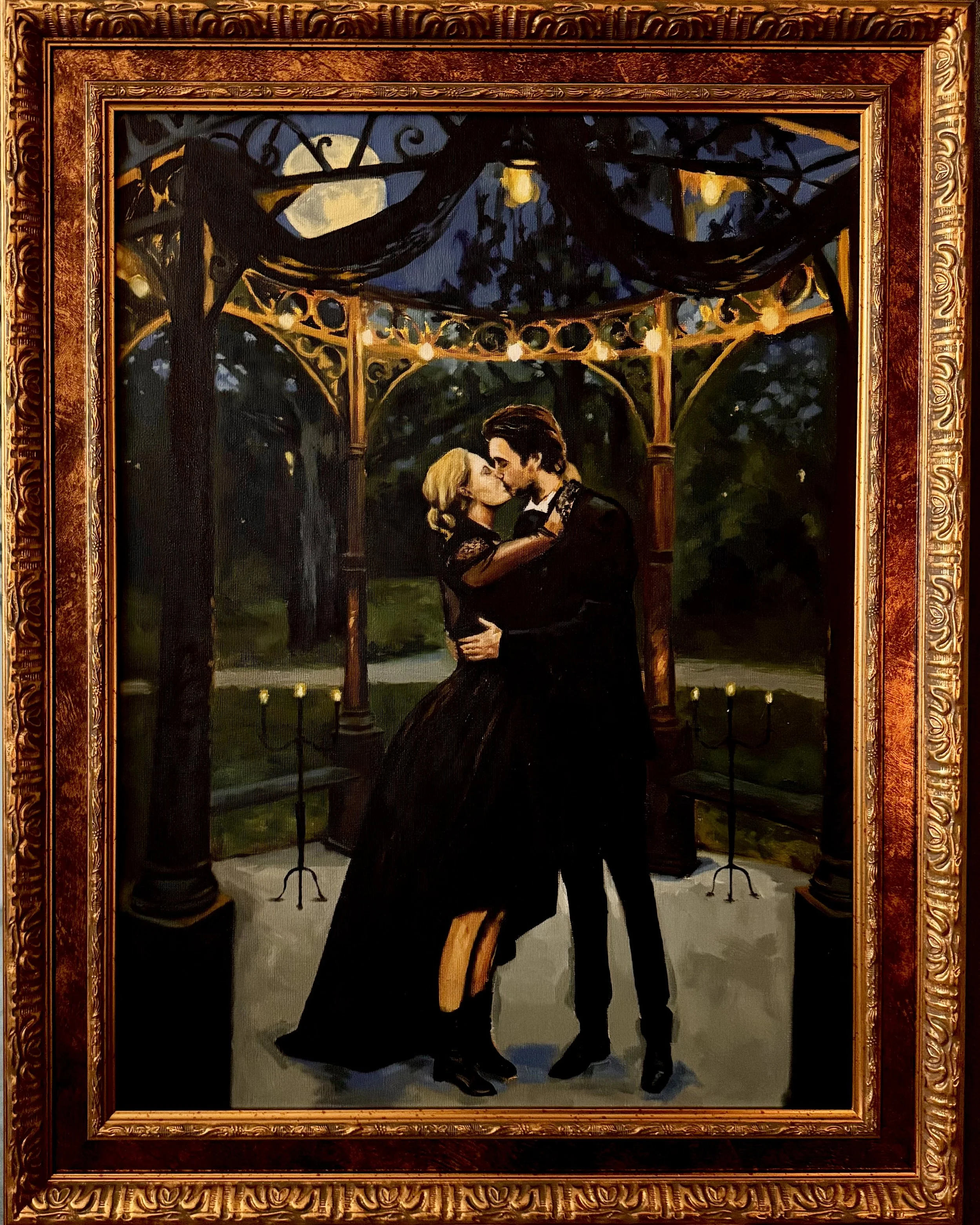 Husband and Wife kissing in a dark, warmly lit outdoor scene