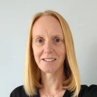 Portrait of Vicky Brentnall with blonde hair and a black top