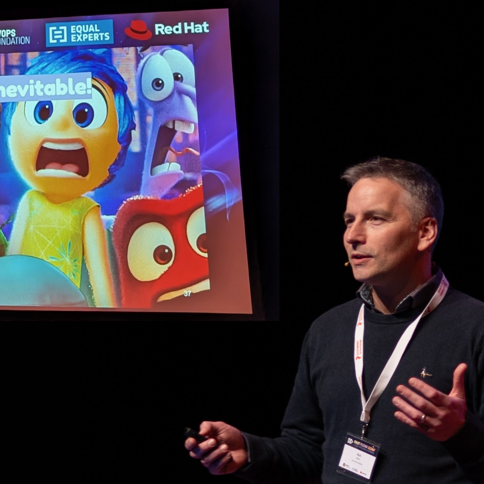 Rich Allen giving a presentation on stage with a slide showing animated characters, including a yellow character with blue hair, a purple octopus, a red creature, and a blue logo with the text 'EQUAL EXPERTS' and 'Red Hat'.