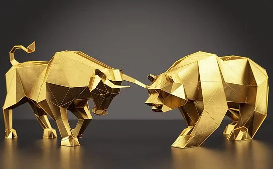 Gold-colored geometric sculpture of a bull facing a bear with their horns touching.