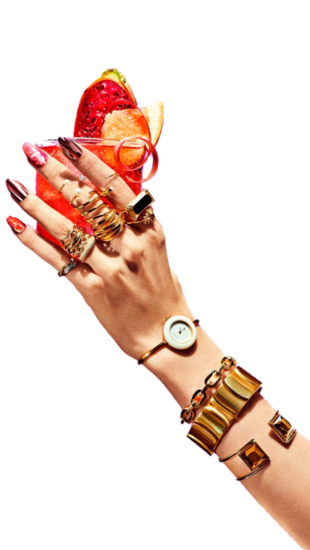 Hand holding a cocktail glass with fruit garnish, representing the lifestyle and creative culture agencies enjoy when production is handled by The Aux Co.