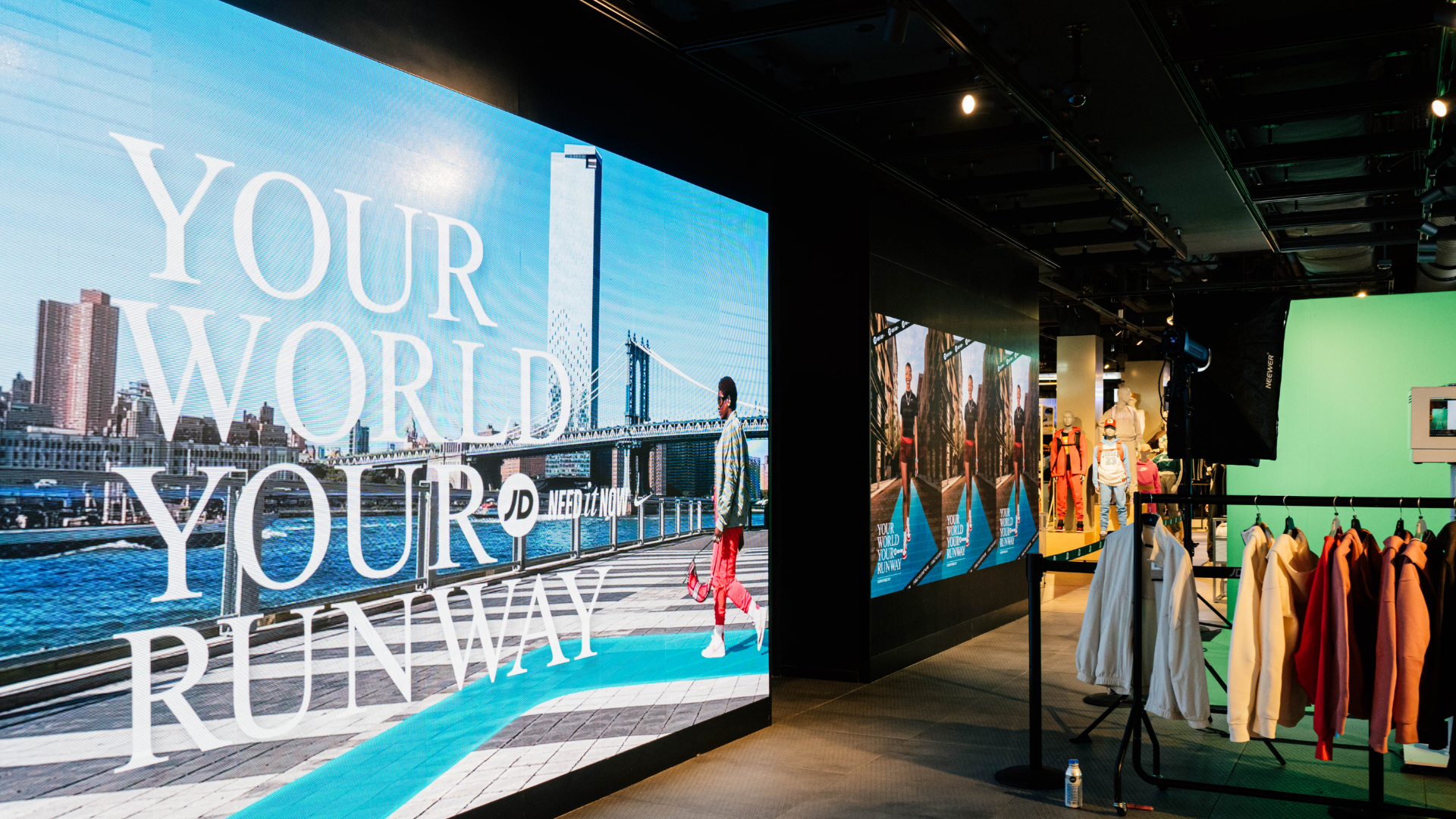 Indoor retail environment from a commercial campaign produced by The Aux Co featuring digital advertising screens and styled mannequins.