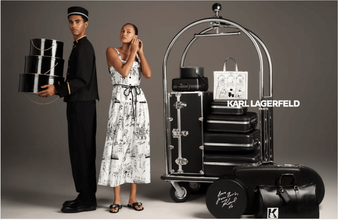 A man dressed in a black uniform holding black hats, and a woman in a white patterned dress with black print, standing next to a luggage cart filled with black suitcases and a bag, against a neutral background. The image includes the Karl Lagerfeld P