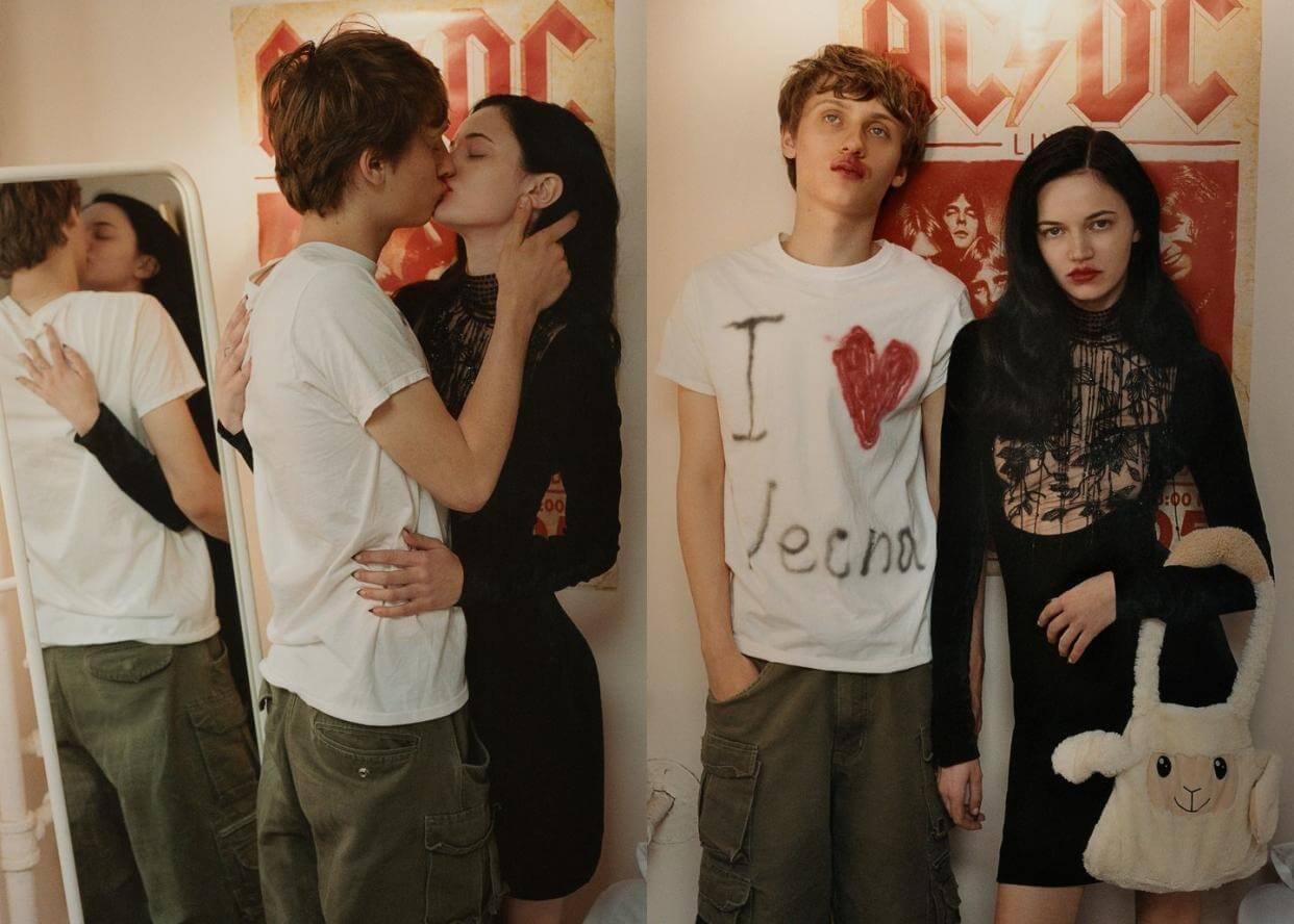Two young couples, one kissing and one standing with a woman, in front of an AC/DC poster. The couple on the left is exchanging a kiss, with a mirror reflecting them. The couple on the right is standing with a girl holding a plush llama, wearing casu
