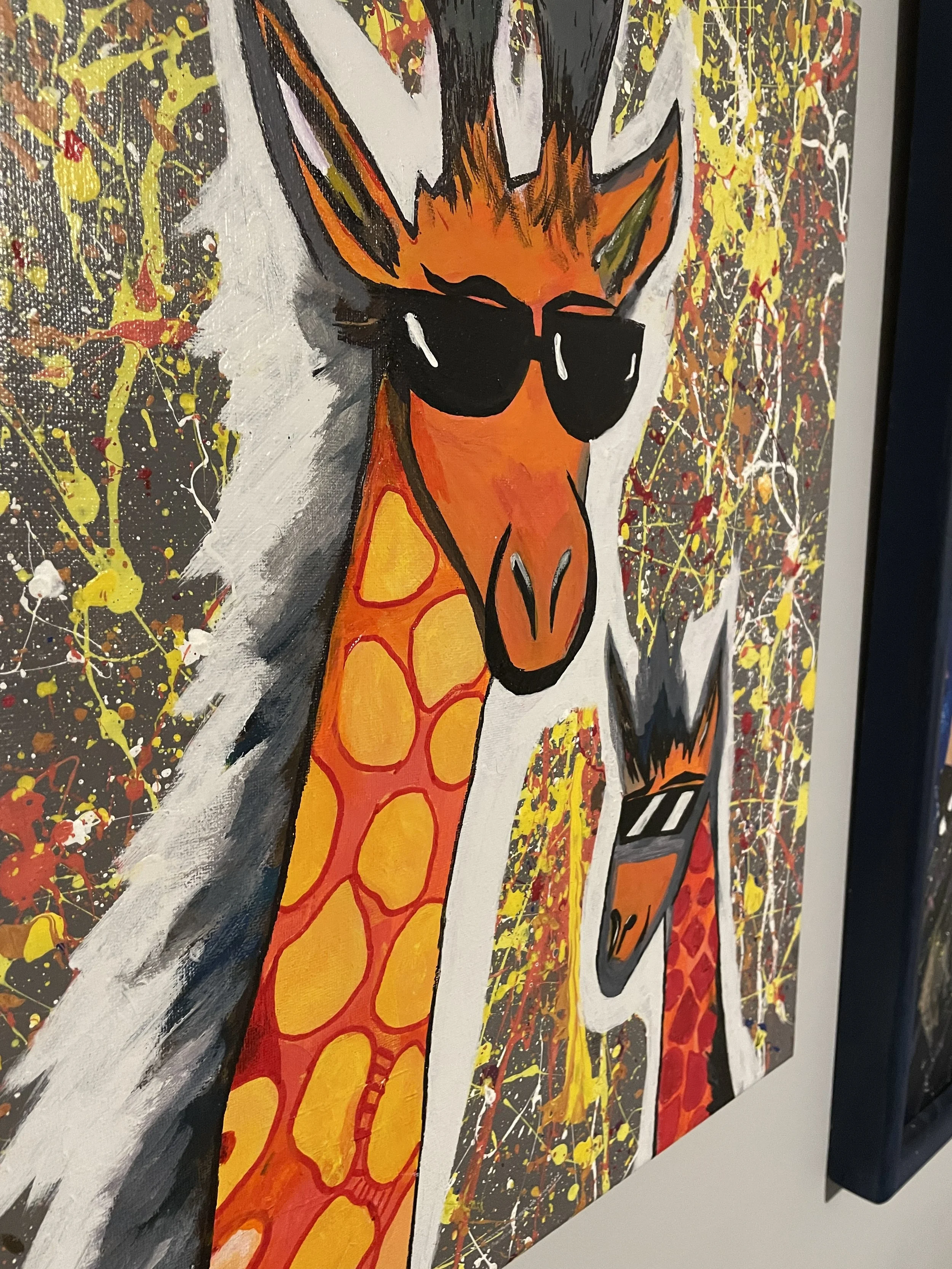 Colorful painting of a cool giraffe wearing sunglasses, with a white mane, set against a splattered yellow, red, black, and white background.