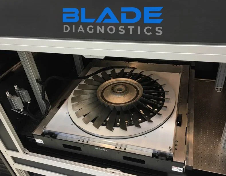A Blade Diagnostics testing machine with a circular spinning turbine or rotor inside.