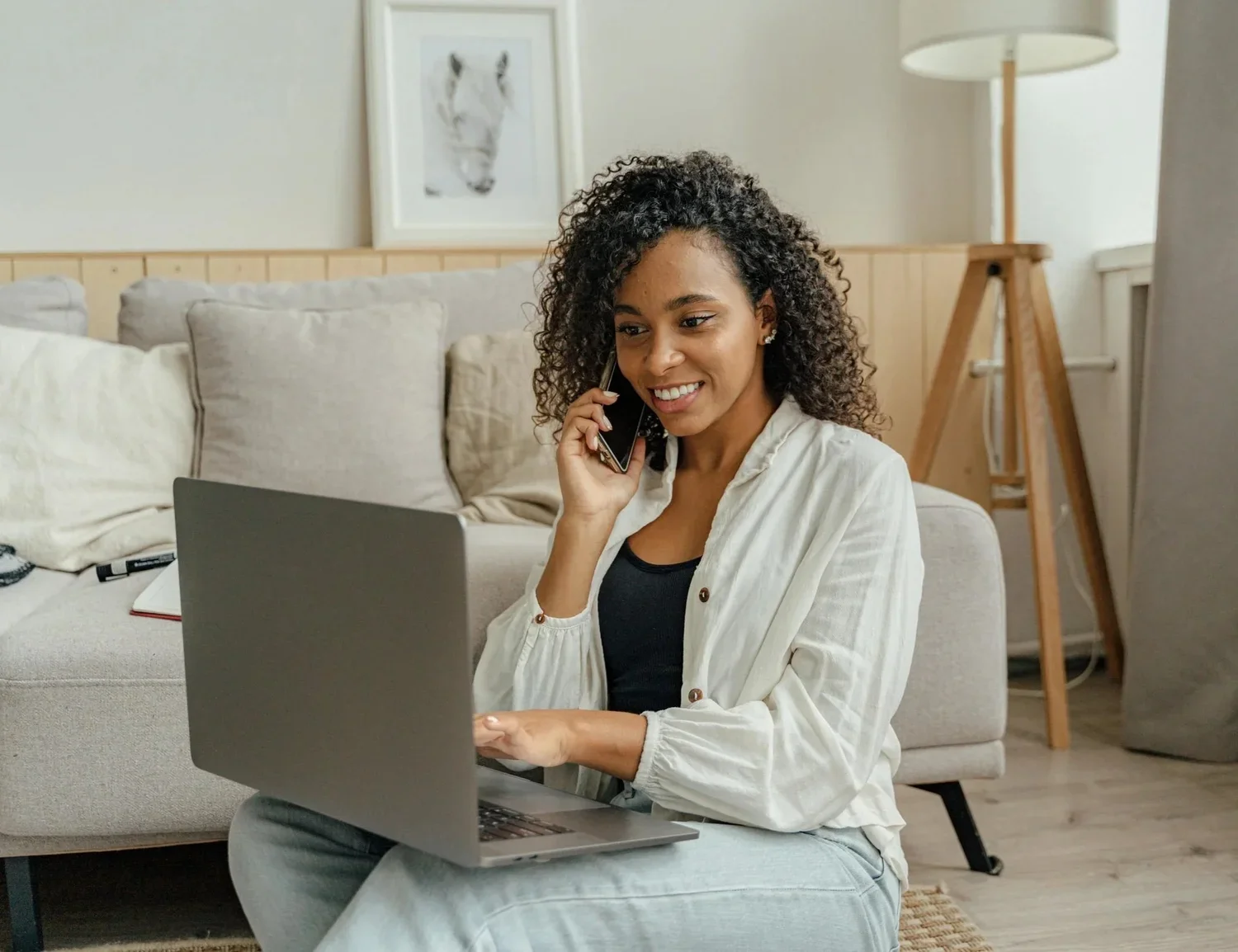 Woman using laptop on phone