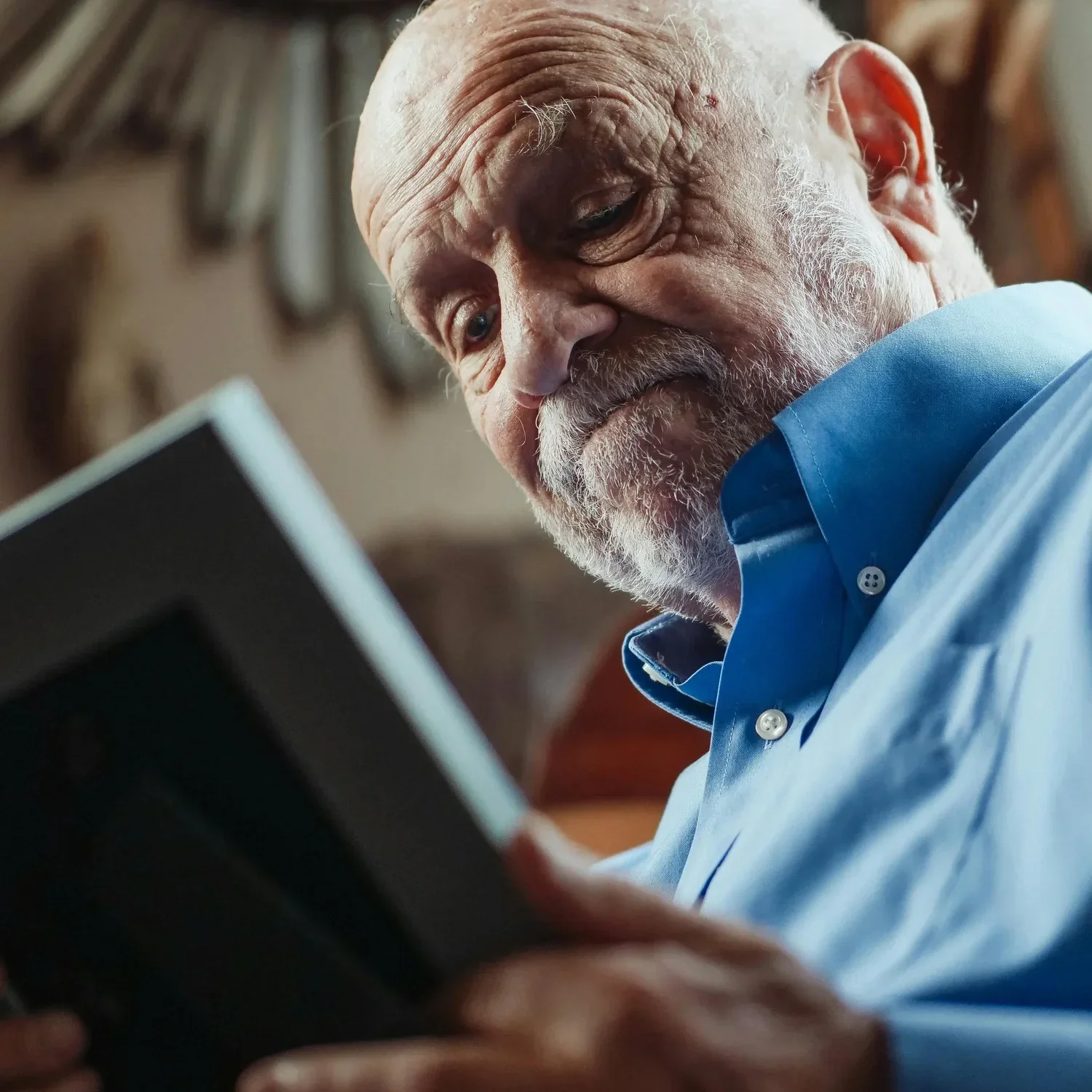 man looking at a framed photo