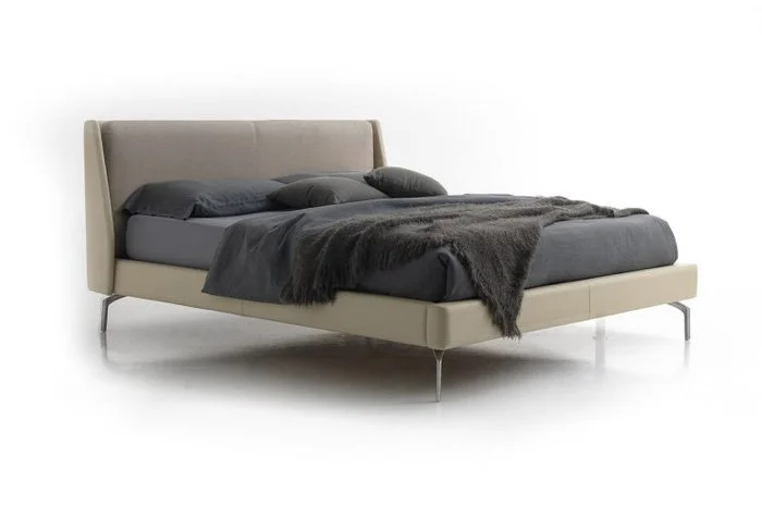 Italian Taylor bed by Albani Divani with beige fabric and distinctive winged headboard at ArkNova Interiors Paphos showroom in Cyprus