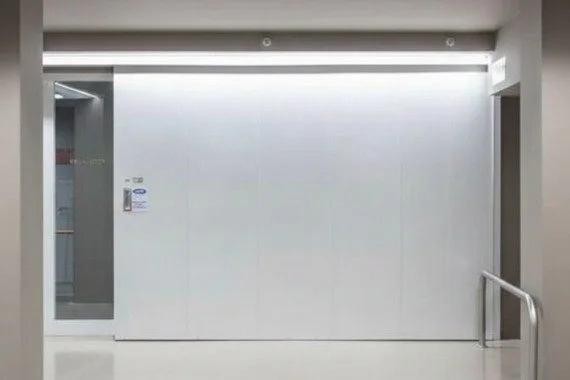 Novoferm Novoslide Italian white sliding industrial door in corridor at ArkNova Interiors Paphos Cyprus