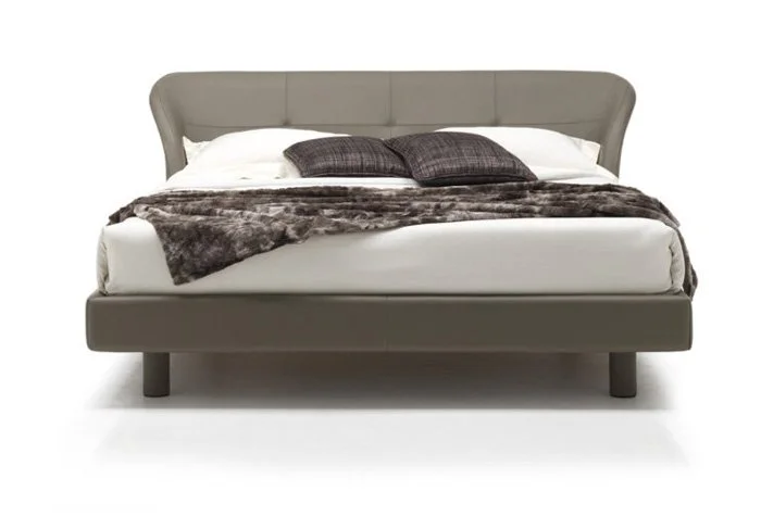 Italian Andria bed by Albani Divani with elegant curved gray leather headboard at ArkNova Interiors Paphos showroom in Cyprus