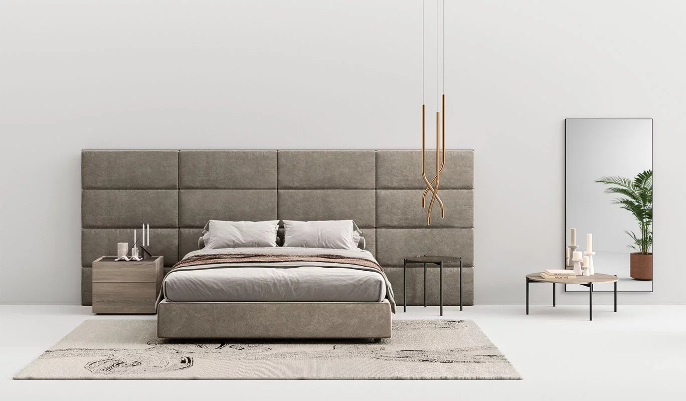 Italian Boiserie bed by Cinquepuntozero with expansive gray modular upholstered headboard wall at ArkNova Interiors Paphos showroom in Cyprus