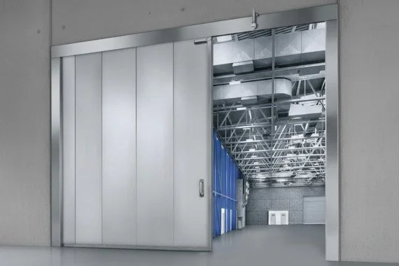 Novoferm Novoslide Industry Italian silver sliding industrial door open to warehouse at ArkNova Interiors Paphos Cyprus