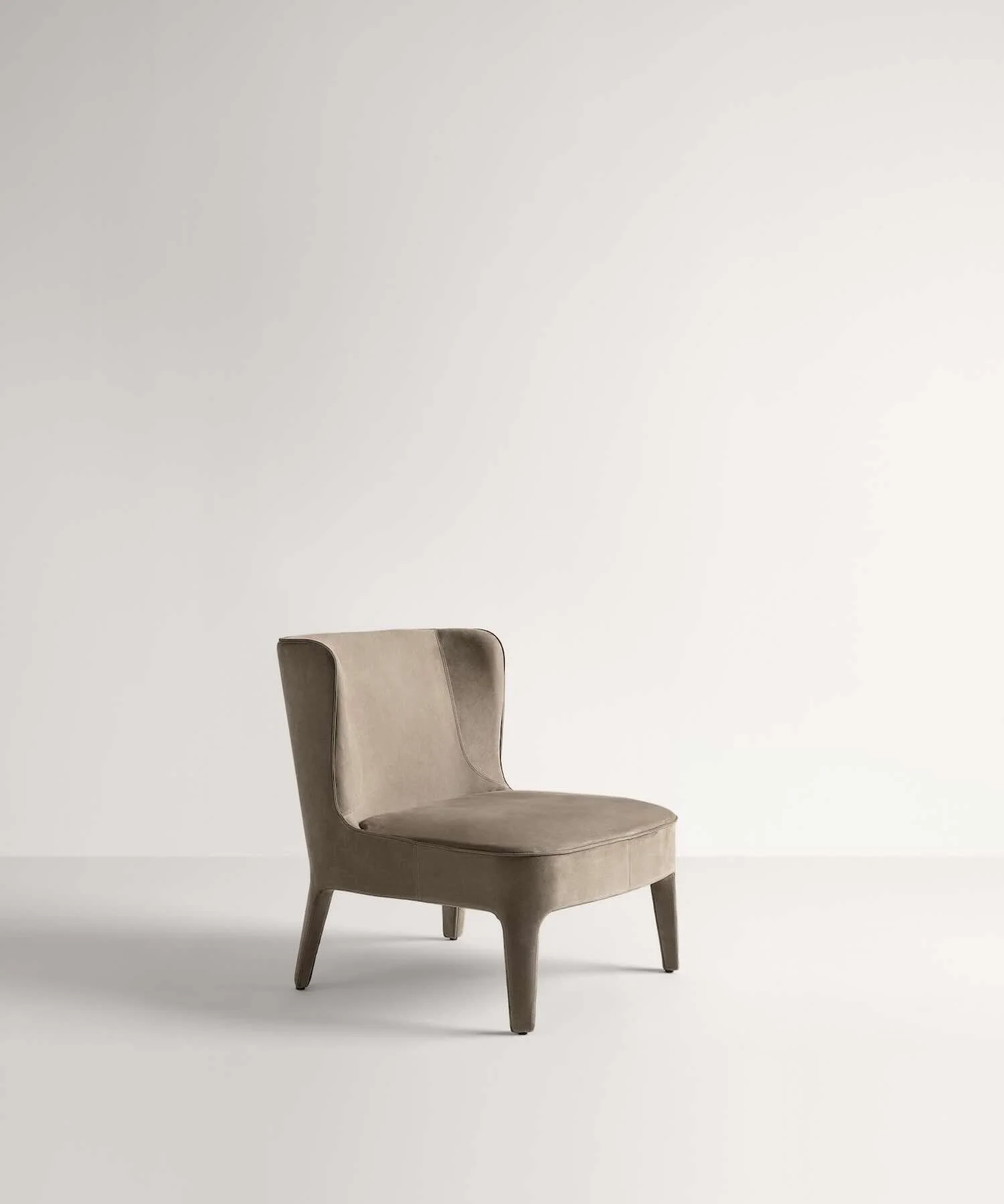 Frag Public L Italian beige suede high-back curved armchair at ArkNova Interiors Paphos showroom in Cyprus