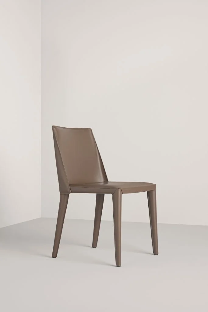 Frag Dindi Italian brown leather dining chair with sleek high back and wooden legs at ArkNova Interiors Paphos showroom in Cyprus