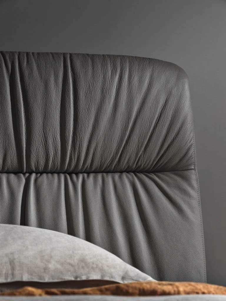 Close-up of Italian Otto bed by Frag showing detailed gray ruched leather headboard at ArkNova Interiors Paphos Cyprus