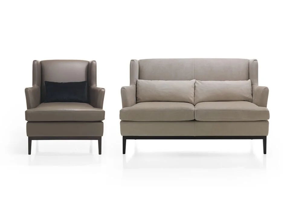 Albani Divani Barbara Italian beige leather armchair with black pillow at ArkNova Interiors Paphos showroom in Cyprus