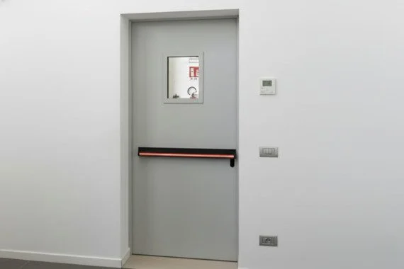 Novoferm Elite+ Italian gray fire-rated door with vision panel and horizontal panic bar at ArkNova Interiors Paphos Cyprus