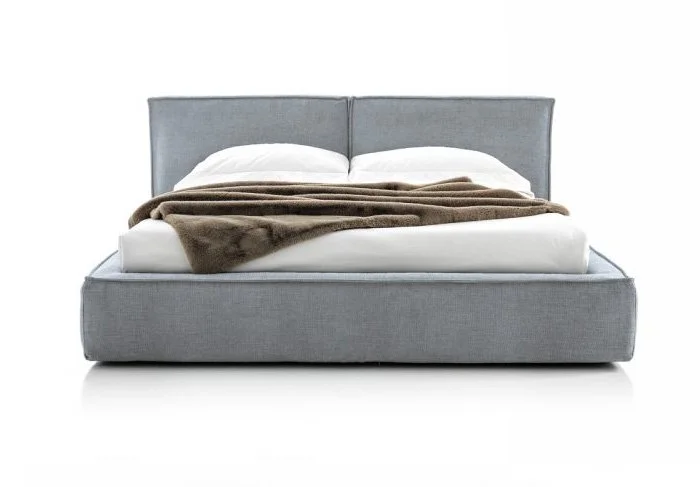 Italian Oasi BED by Albani Divani featuring soft gray fabric upholstery and thick comfortable base at ArkNova Interiors Paphos showroom in Cyprus