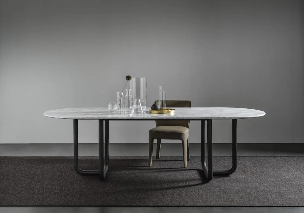 Frag Public Italian beige leather dining chair at marble table at ArkNova Interiors Paphos showroom in Cyprus