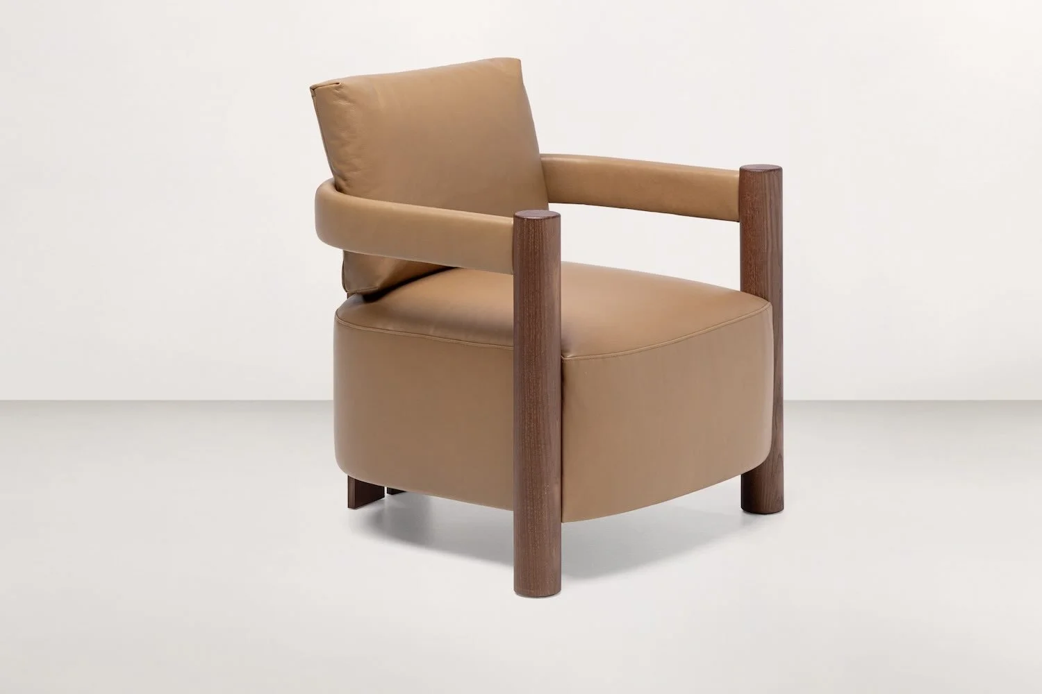 Frag Cloti Italian tan leather armchair with thick wooden arms at ArkNova Interiors Paphos showroom in Cyprus