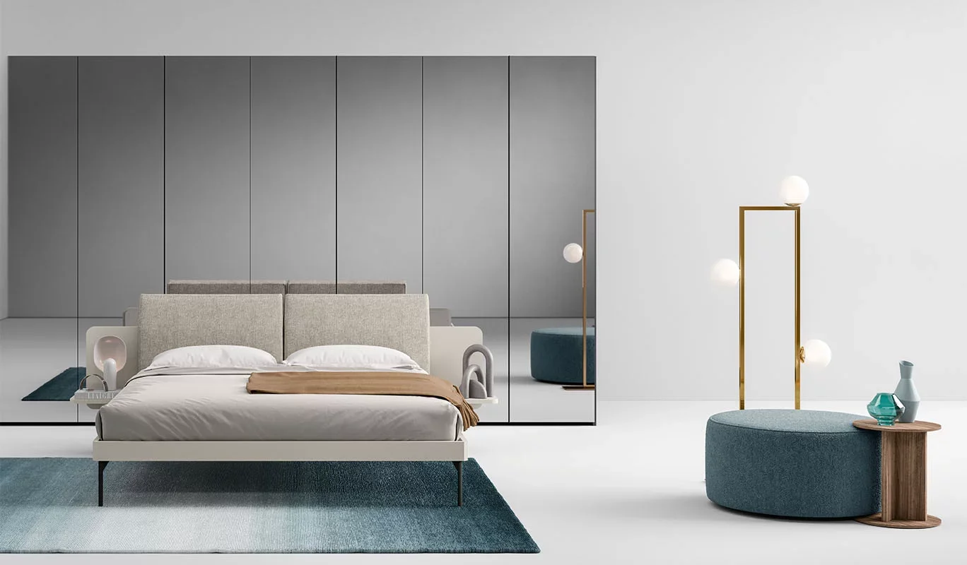 Italian Auro bed by Cinquepuntozero with large gray upholstered panel headboard at ArkNova Interiors Paphos showroom in Cyprus