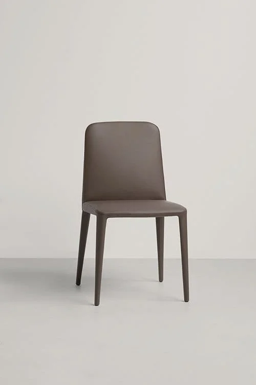 Frag Elf Italian brown leather dining chair with wooden legs at ArkNova Interiors Paphos showroom in Cyprus