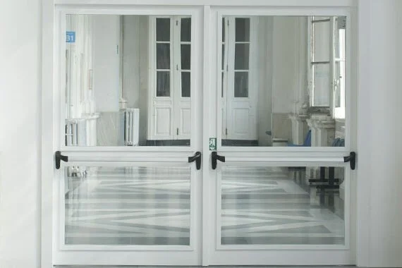 Novoferm Novoglass+ Italian white double glass fire-rated doors with black handles and panic bars at ArkNova Interiors Paphos Cyprus