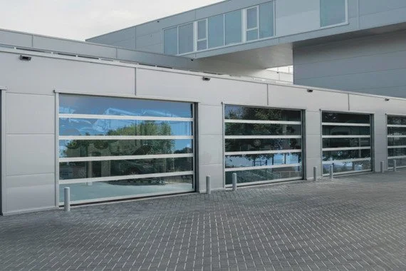 Novoferm NovoLux Italian glazed sectional industrial doors on modern commercial building at ArkNova Interiors Paphos Cyprus