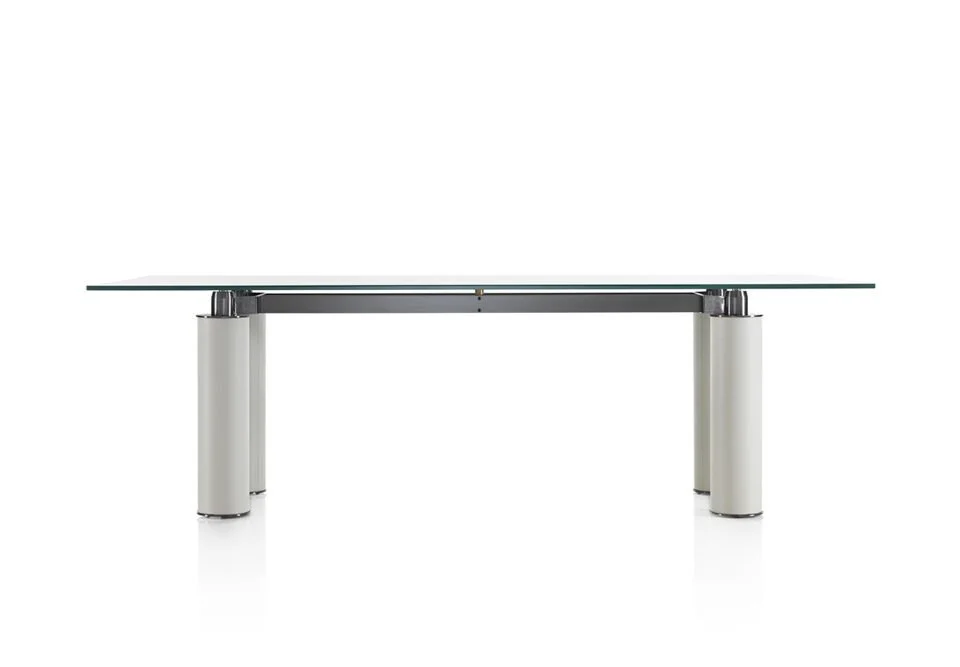 Albani Divani Anima Italian glass top dining table with cylindrical white bases and chrome details at ArkNova Interiors Paphos showroom in Cyprus